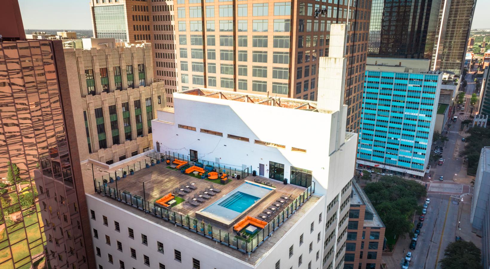 a high angle view of a building with a rooftop pool