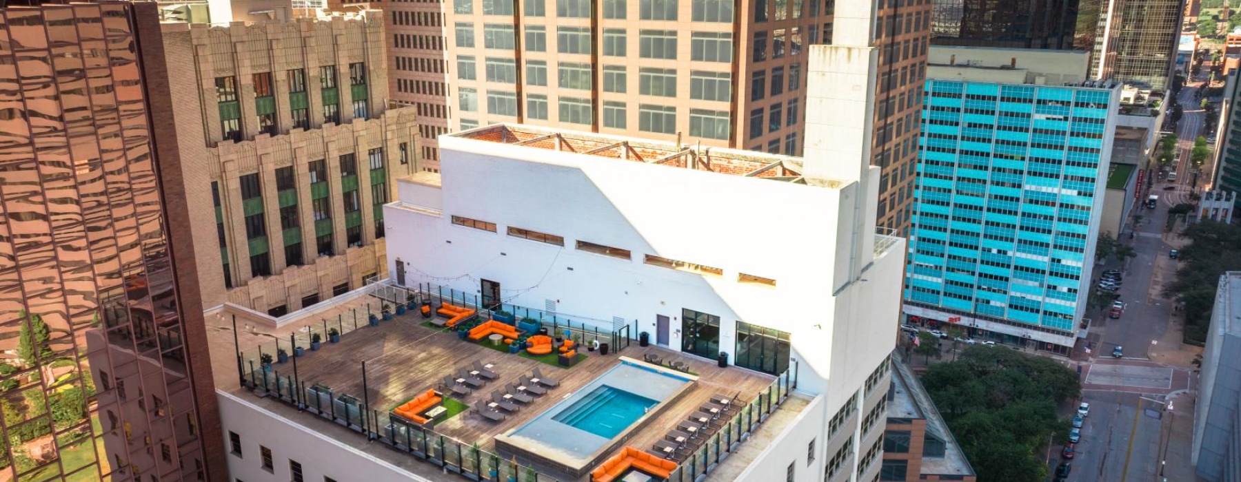 a high angle view of a building with a rooftop pool