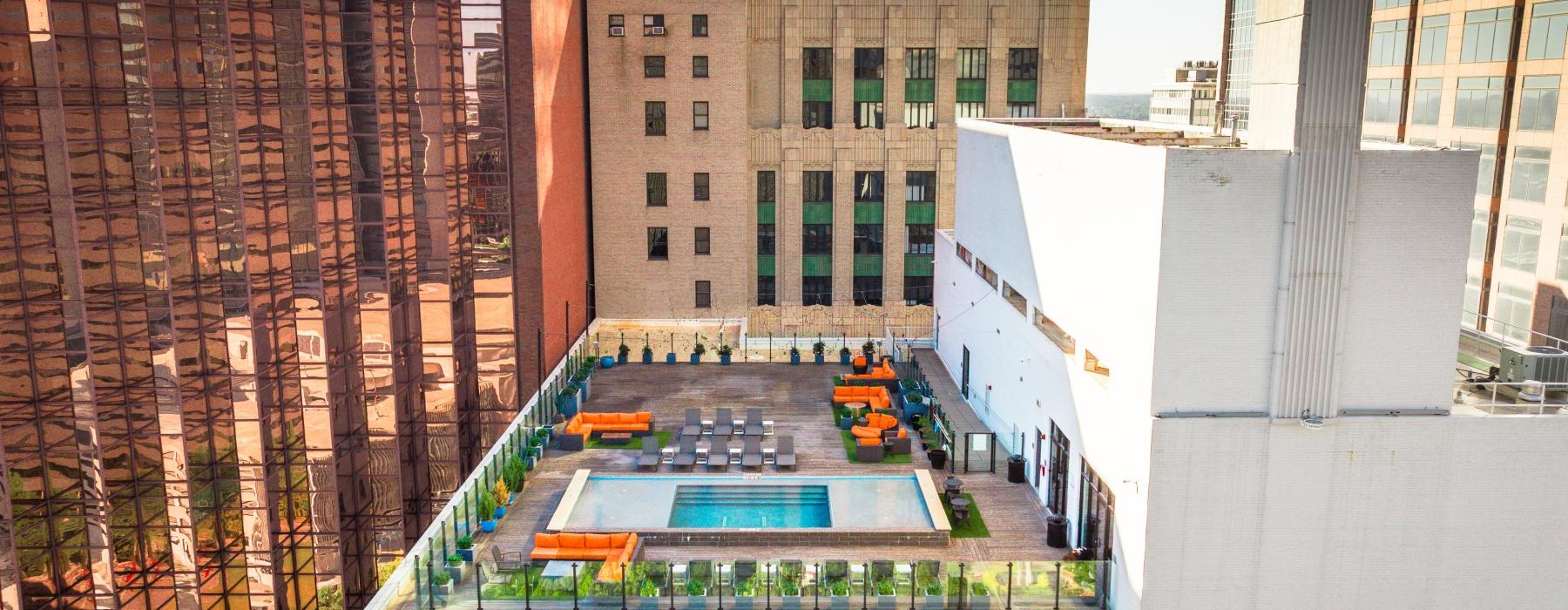 Rooftop pool with downtown Dallas skyline views at 1900 Pacific apartments